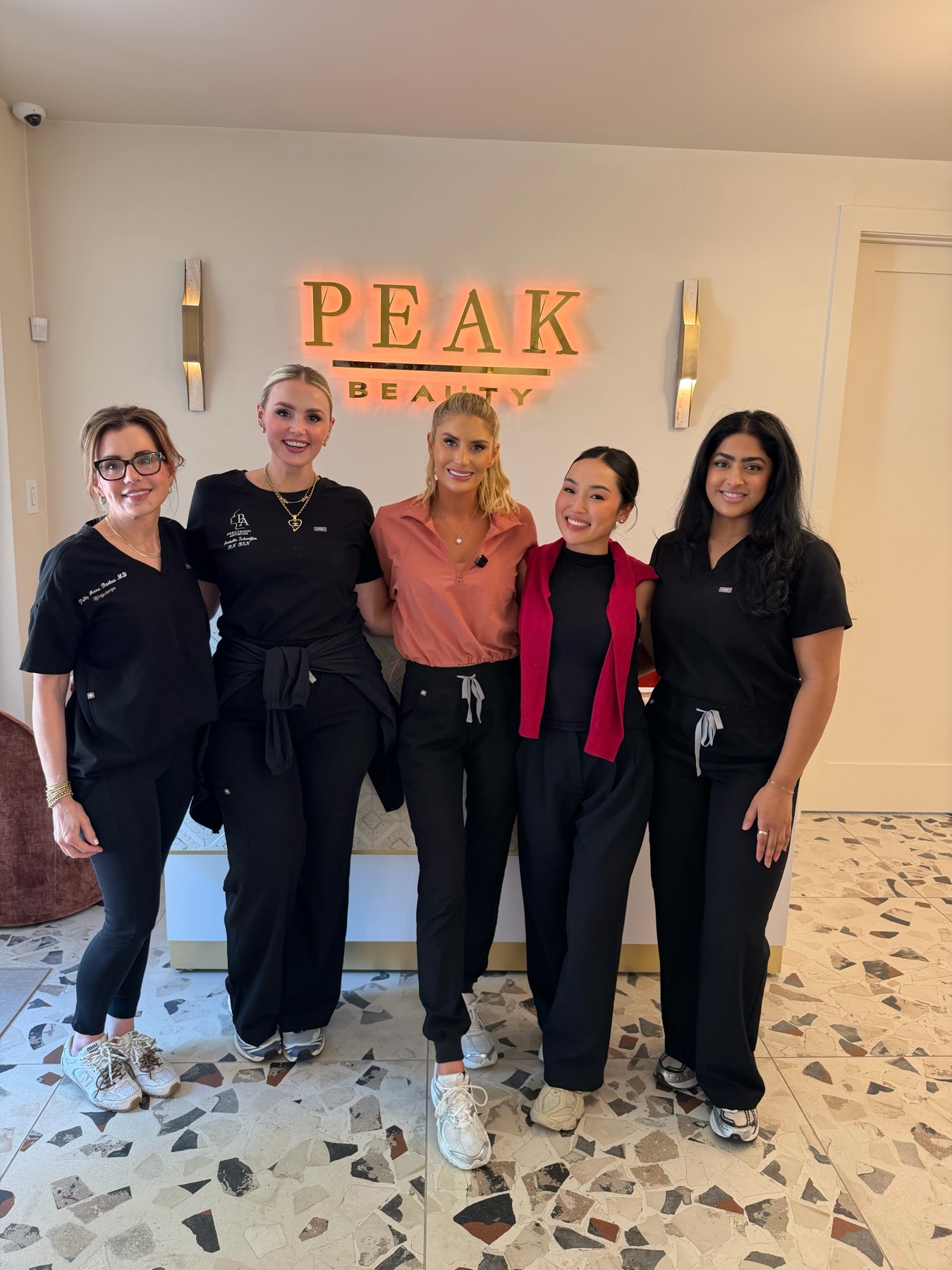 Shadow Experience providers with the Peak Beauty team in front of the Peak Beauty sign